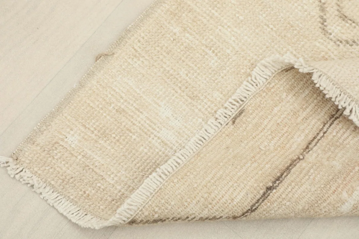 View of the hand-knotted cotton foundation visible from the back of the rug