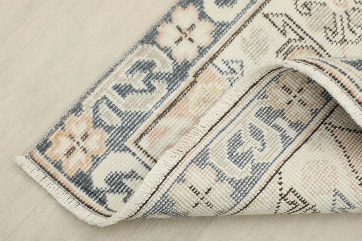 View of the back of the hand-knotted wool pile on cotton foundation, showing the rug's construction.