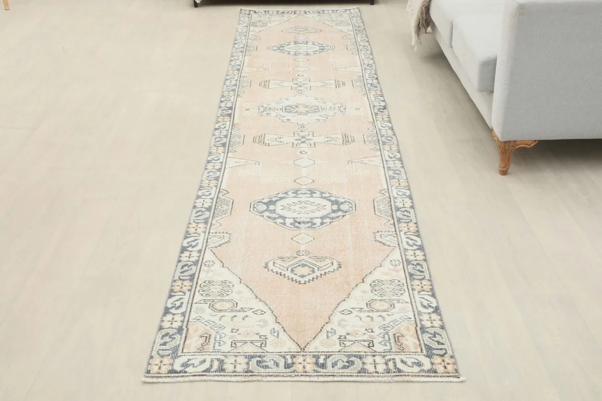 Full overhead view of the rose tribal medallion runner rug in a room, showing its complete design.
