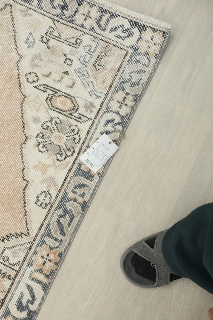 Overhead view showing a foot next to the runner, indicating scale and the low pile texture.