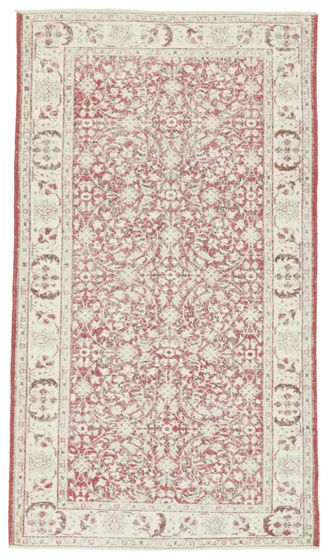 Full overhead view of the rose and ivory vintage Anatolian area rug on a white background