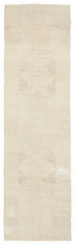 Full top view of the beige tribal Anatolian runner rug on a white background