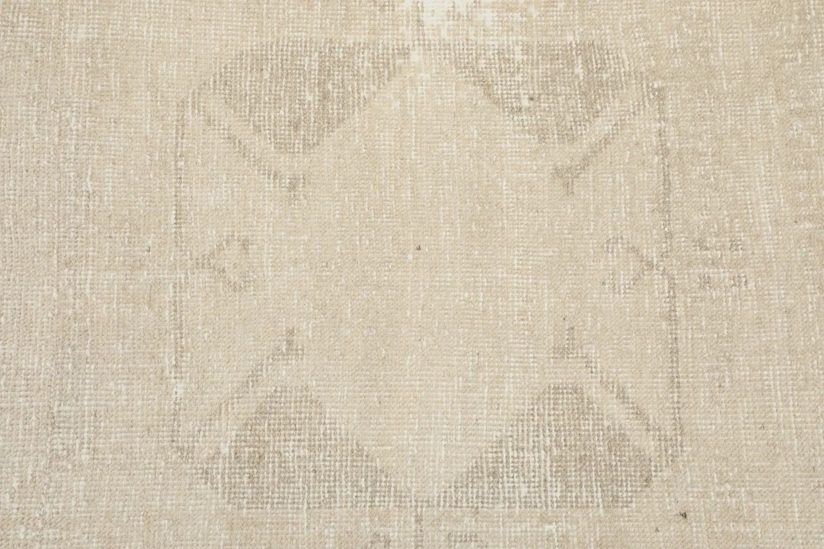 Detailed view of the central tribal pattern on the beige Anatolian runner