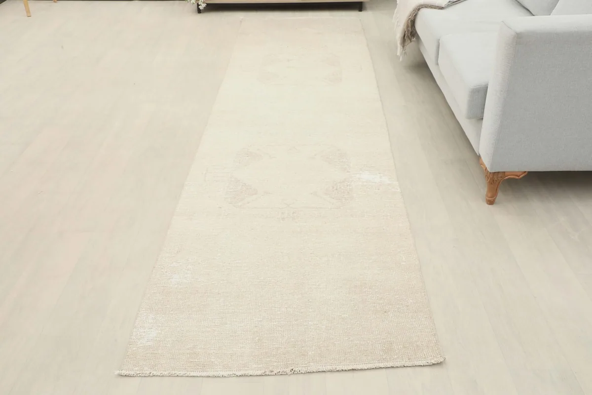 Overhead view of the beige runner rug in a room, showcasing its full length and placement