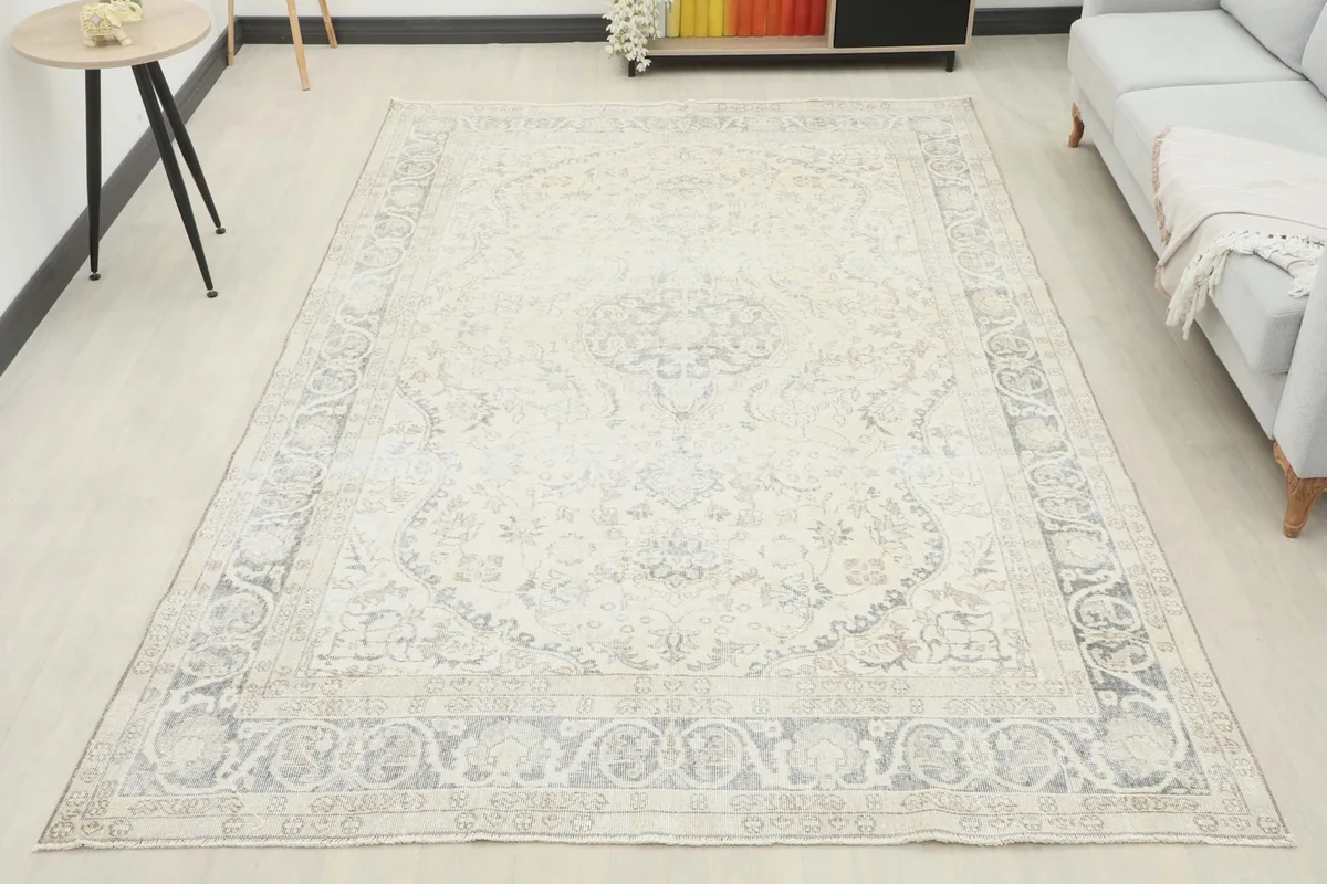 Overhead room view of the ivory and gray vintage rug, showcasing its full size and design in a spacious setting