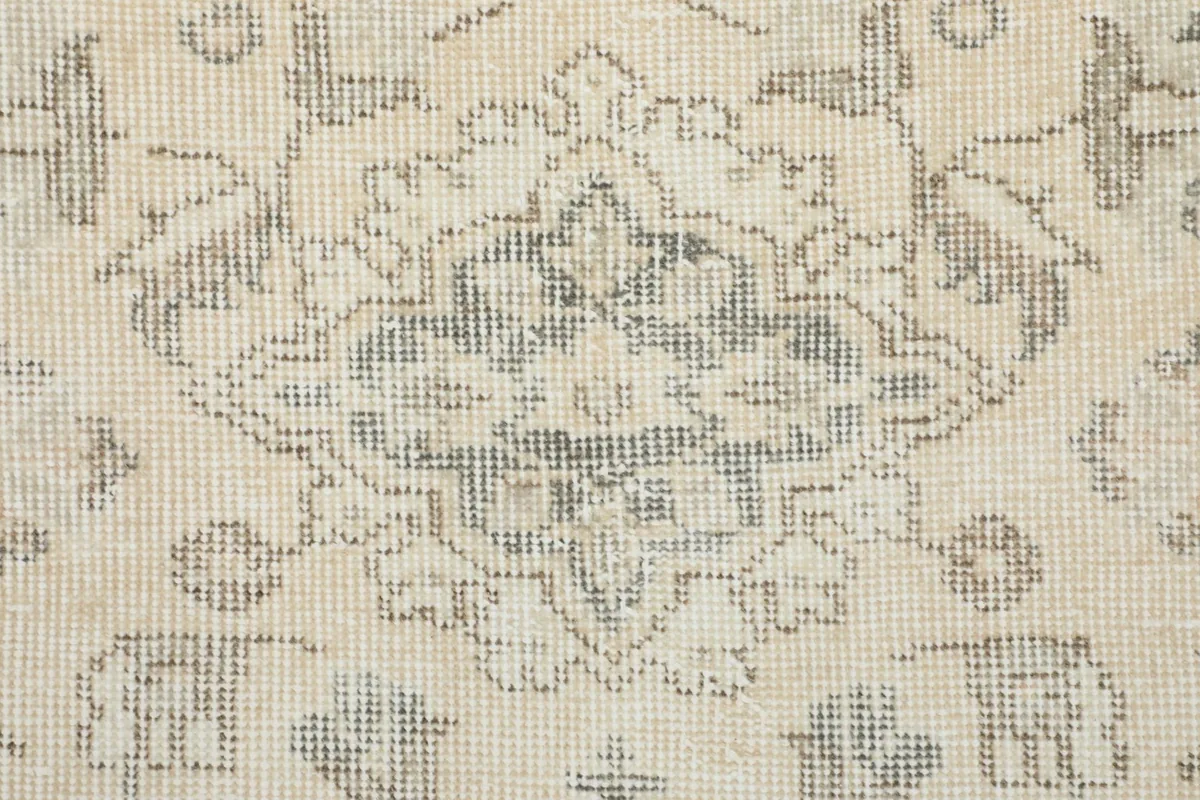 Close-up of the low wool pile, showing the texture and distressed appearance of the gray and ivory weave
