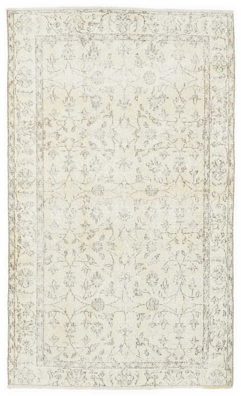 Full overhead view of the ivory floral Anatolian rug on a white background
