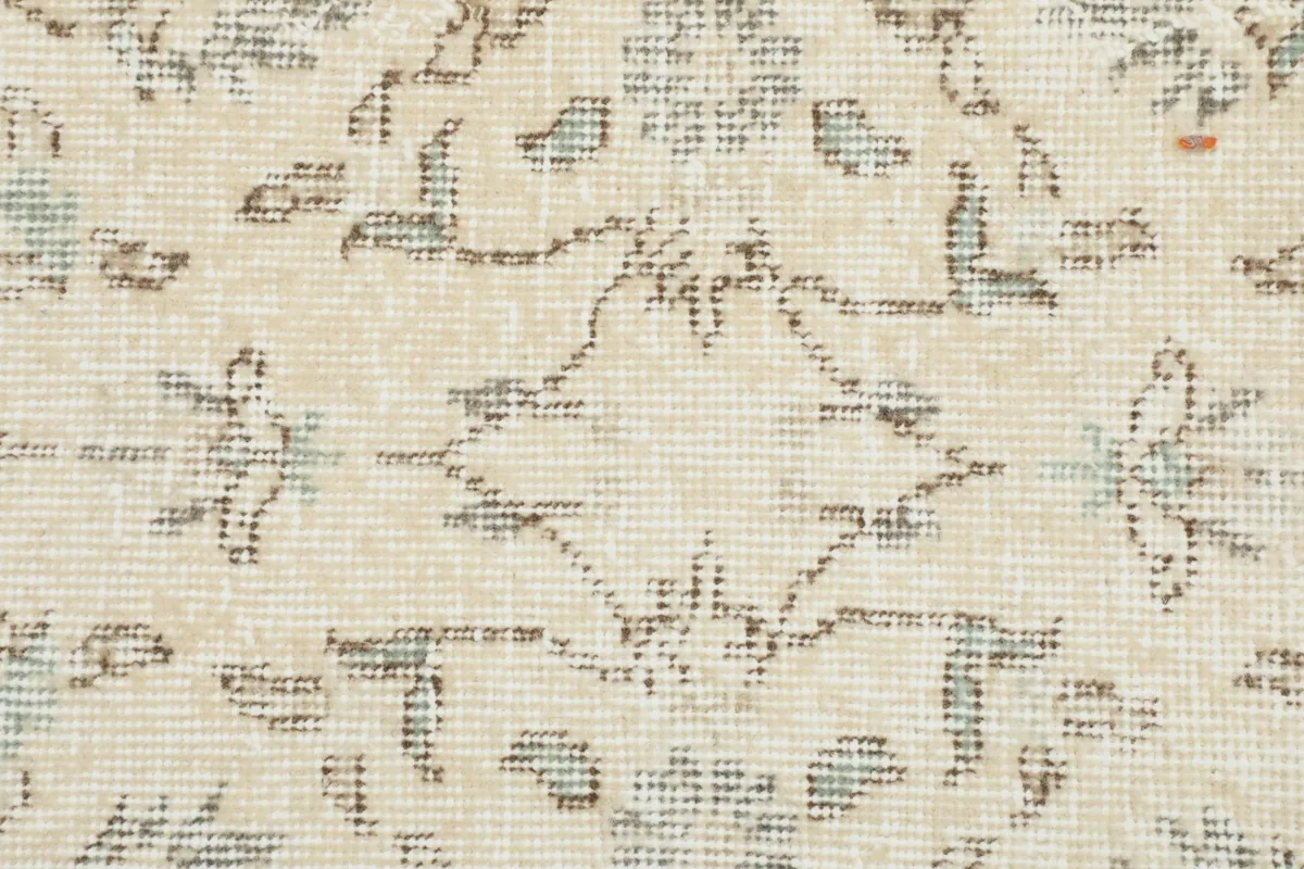 Tight detail of the wool pile showing the individual knots and subtle blue accents