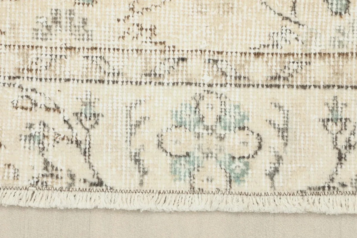 Close-up of the rug's border and short fringe, revealing the intricate patterns