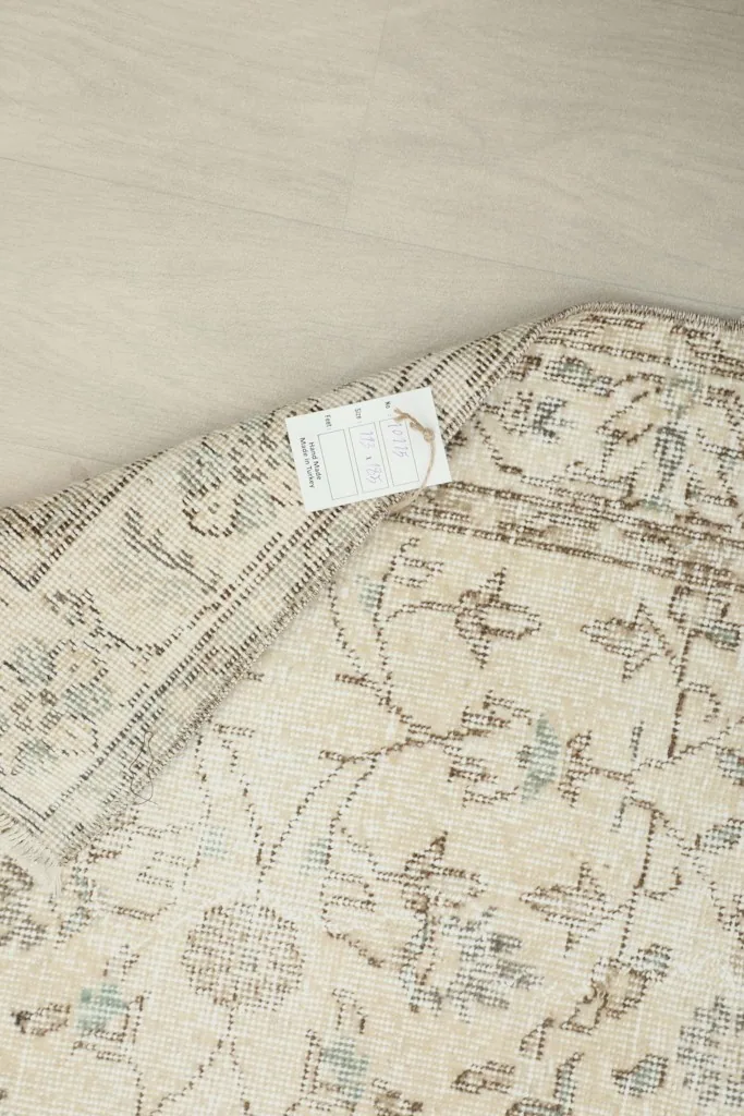 Underside of the rug, showing the hand-knotted cotton foundation and wool pile