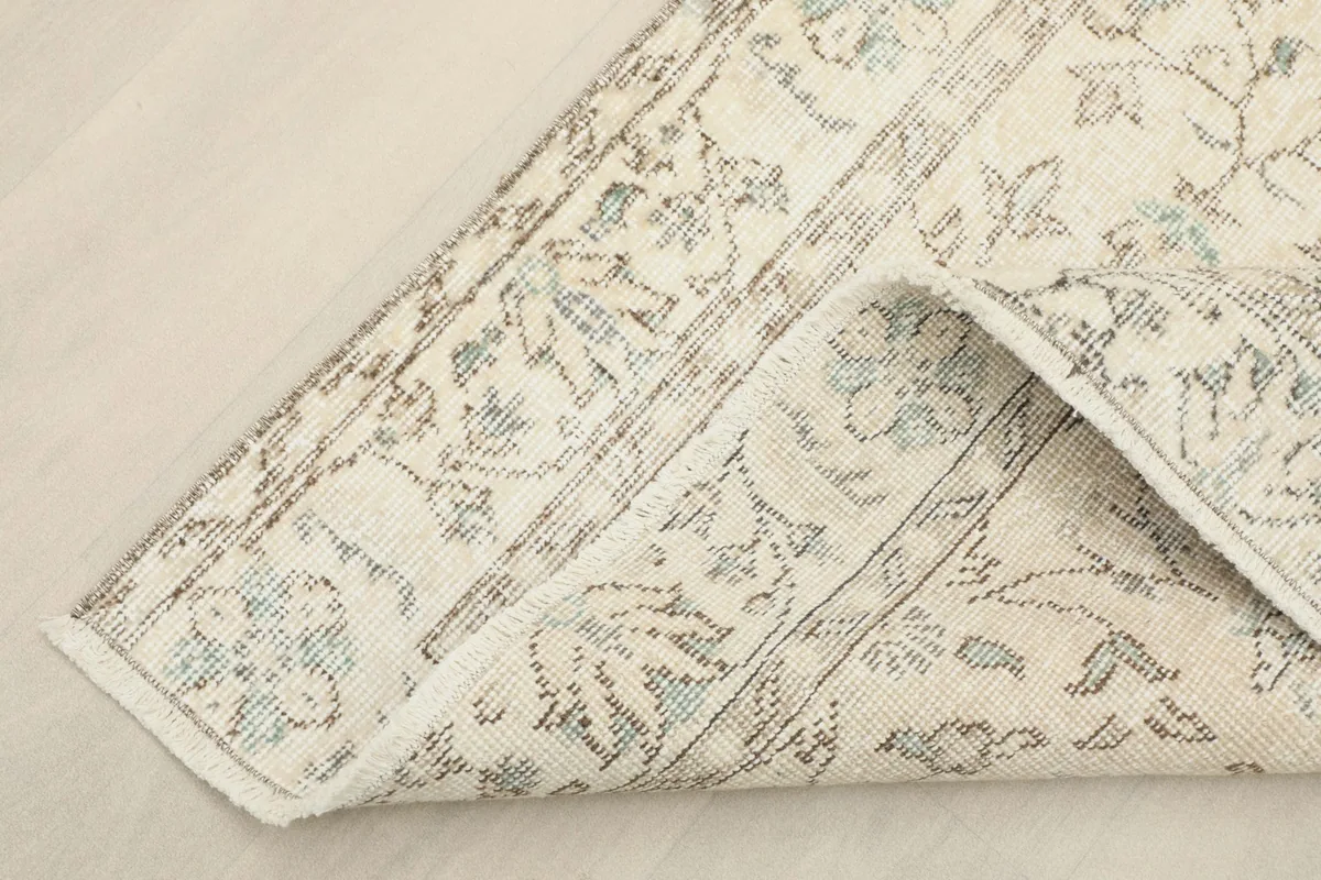 Corner of the rug folded back, showing the thickness and construction