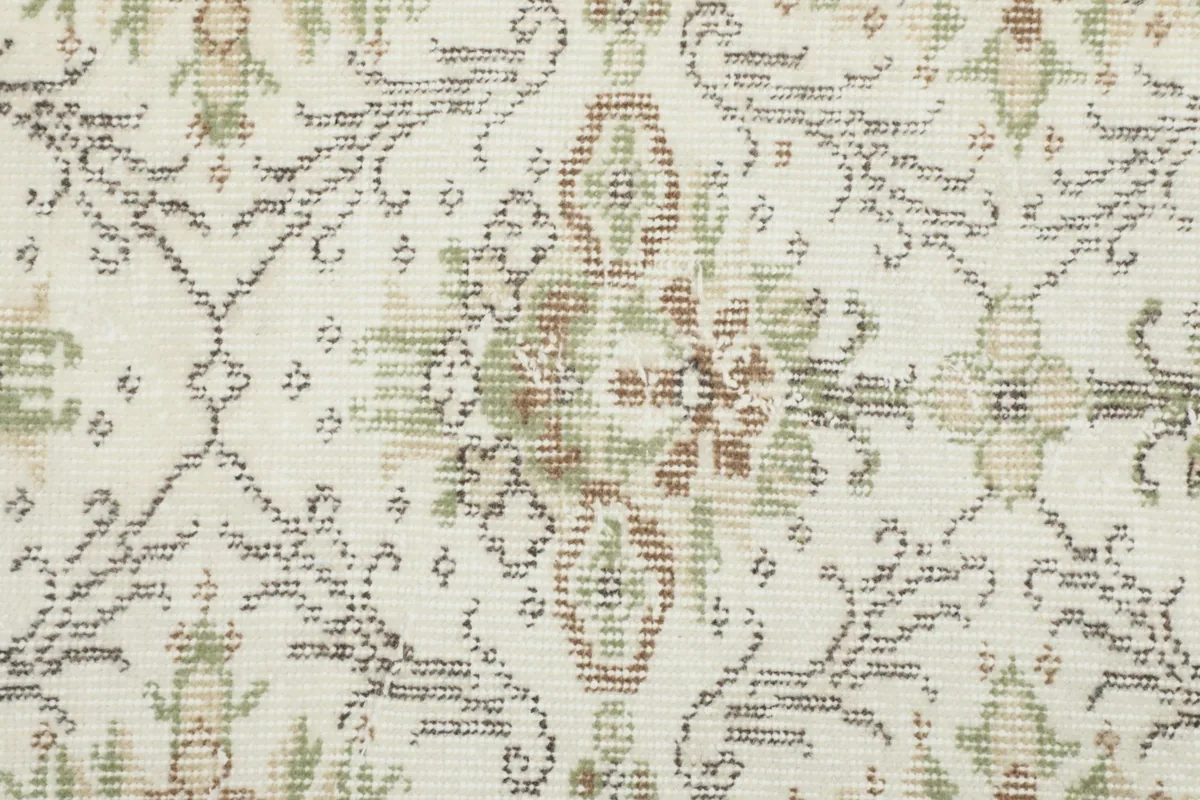 Detailed close-up of the hand-knotted wool pile and faded pattern