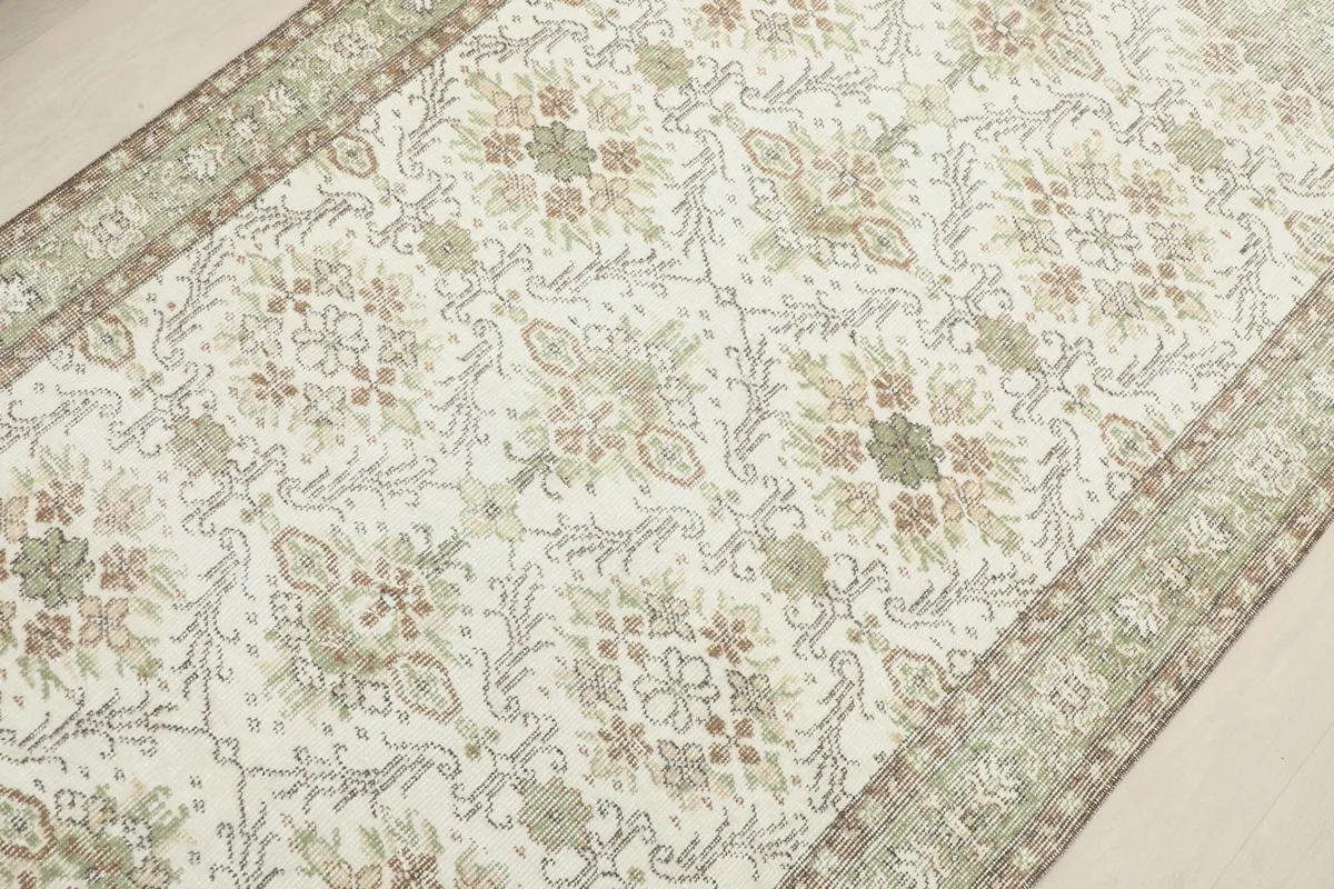 Overhead view of the rug's center, showing the intricate floral and geometric motifs