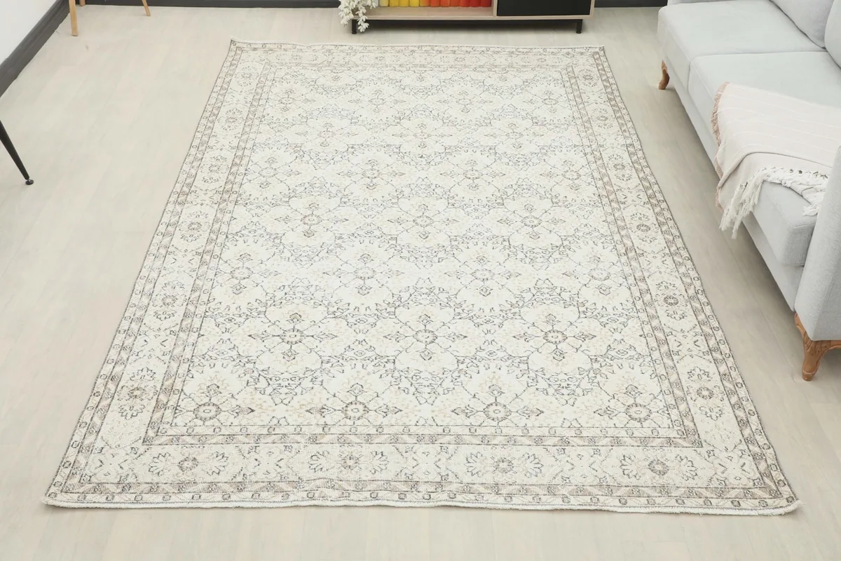 Overhead room view of the 6'8" x 10'0" cream and gray vintage rug, showcasing its full presence.