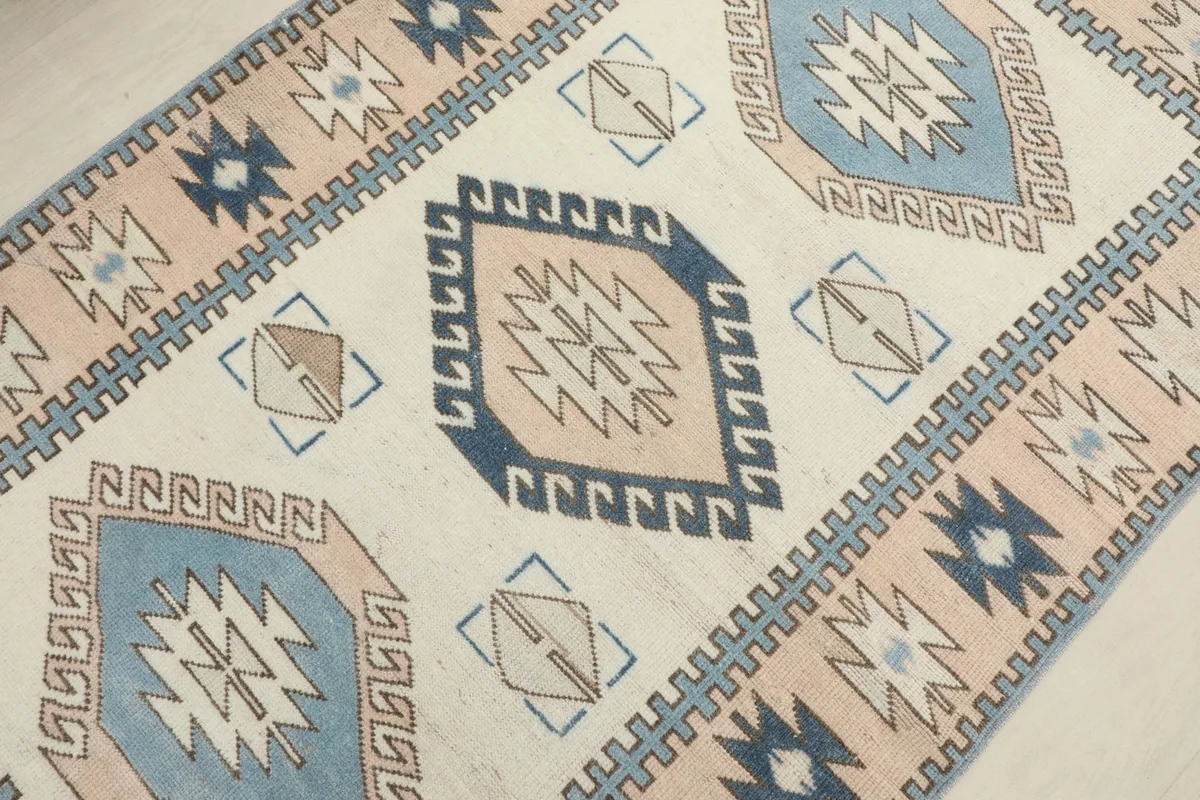 Detailed angled view of the rug's surface, showing the texture and the intricate hand-knotted patterns.