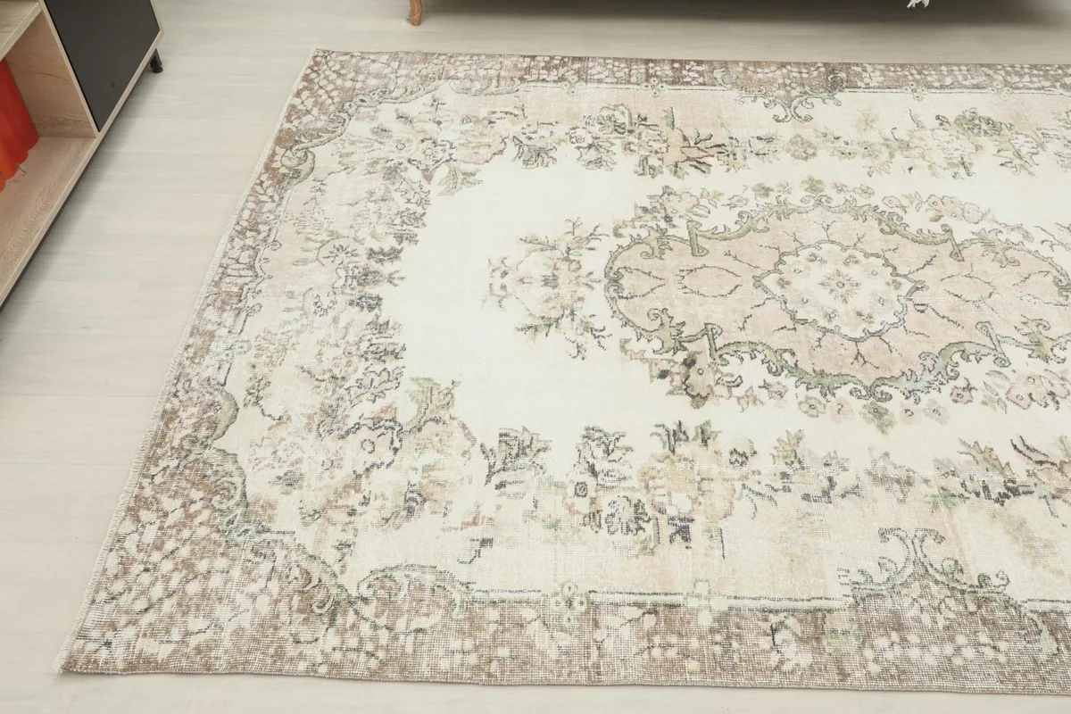 Angled view of the rug from another corner, showing the overall design and colors in a room setting.