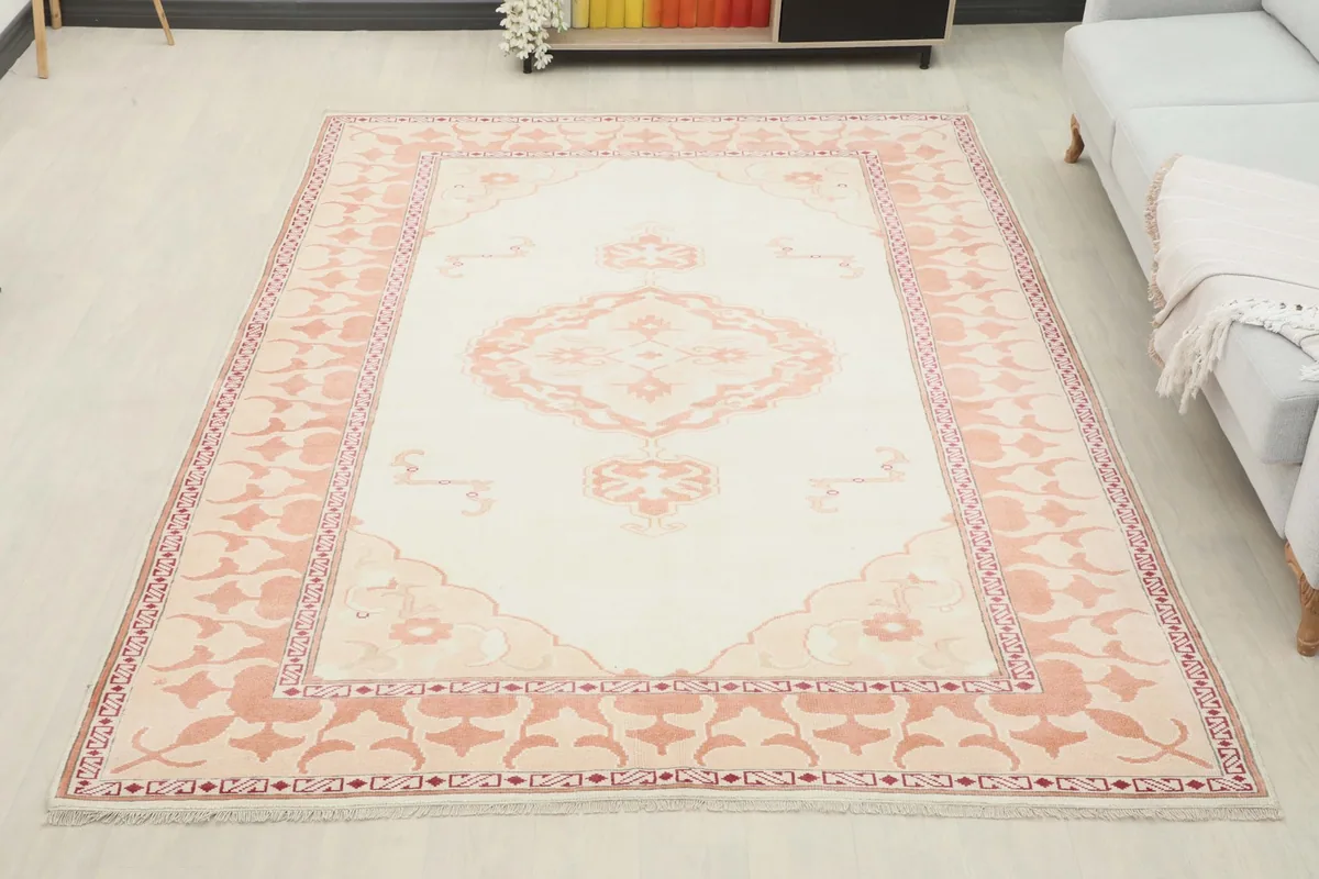 Full room view of the ivory and rose vintage rug placed in a living space