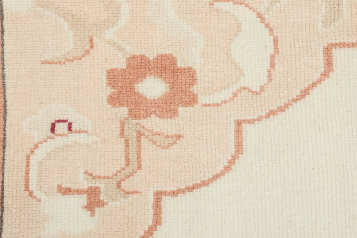 Detail of a rose floral element within the border of the vintage Anatolian rug