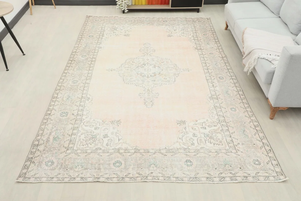 Full room view of the large vintage rose rug laid out in a contemporary living space