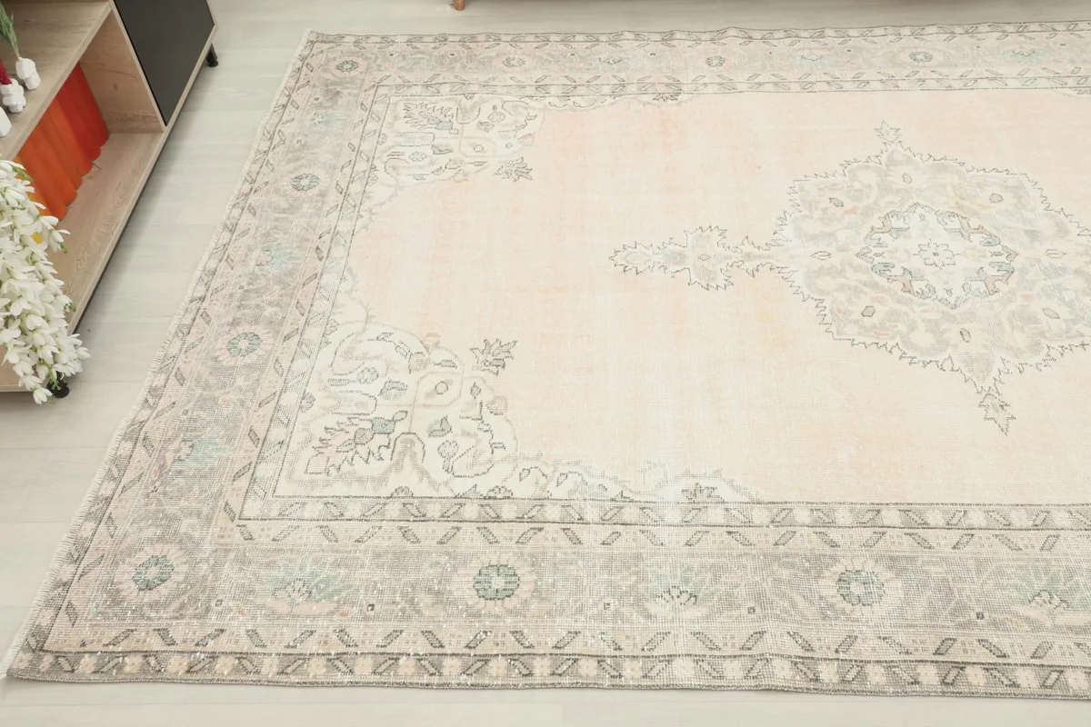 Detail view of the rug's border and a portion of the rose field with subtle patterns