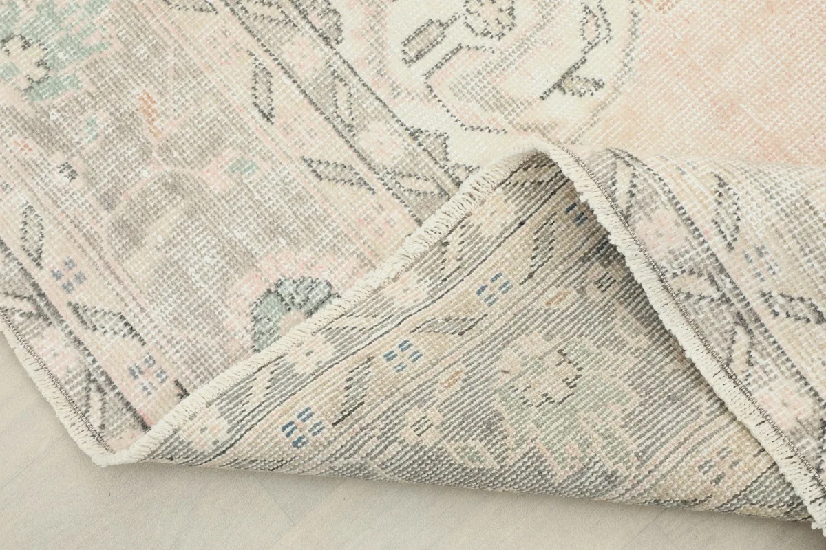 View of the rug's underside, revealing the hand-knotted cotton foundation and wool knots