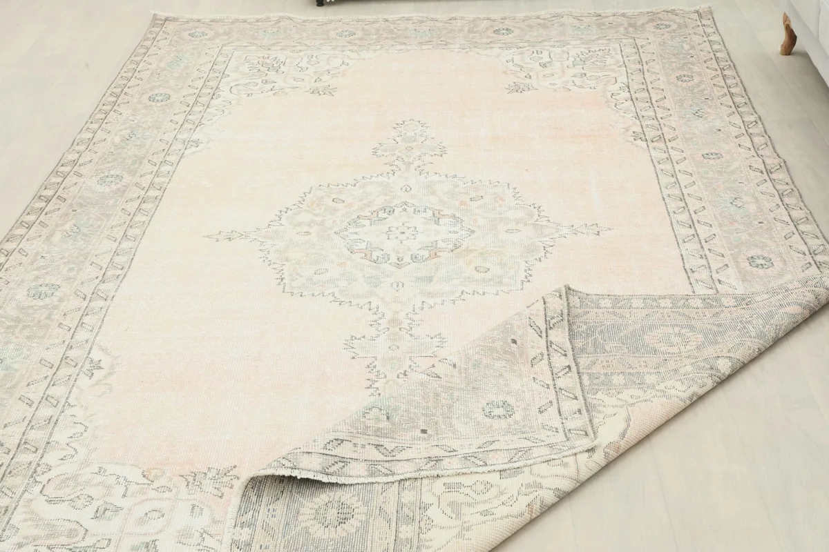 Partial view of the rug folded back, showing the back and front textures