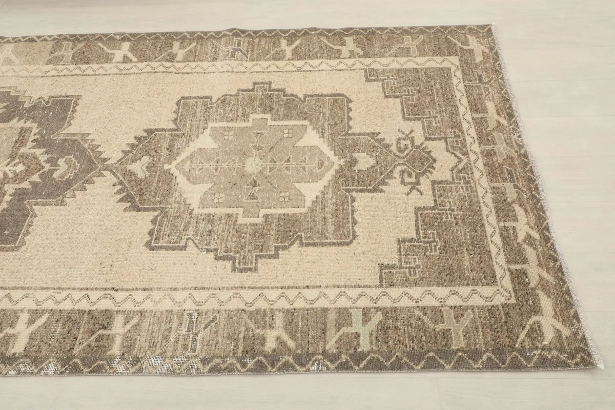 Close-up of the rug's border and central geometric motif from an angle.