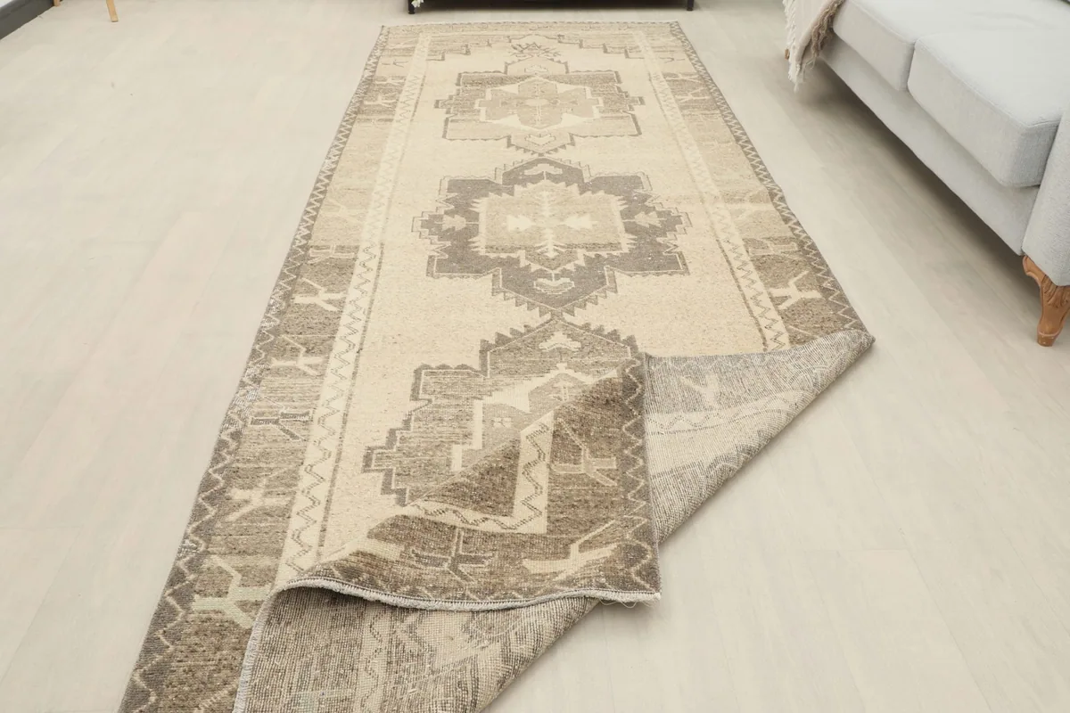 Rug partially folded, showing its flexibility and the consistent pattern along its length.