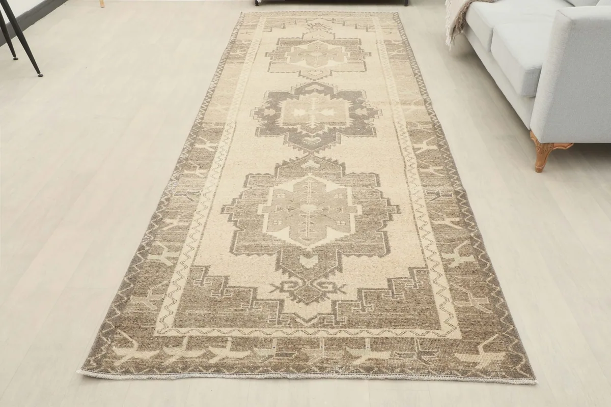 Full overhead view of the beige and brown Anatolian runner rug in a room setting.