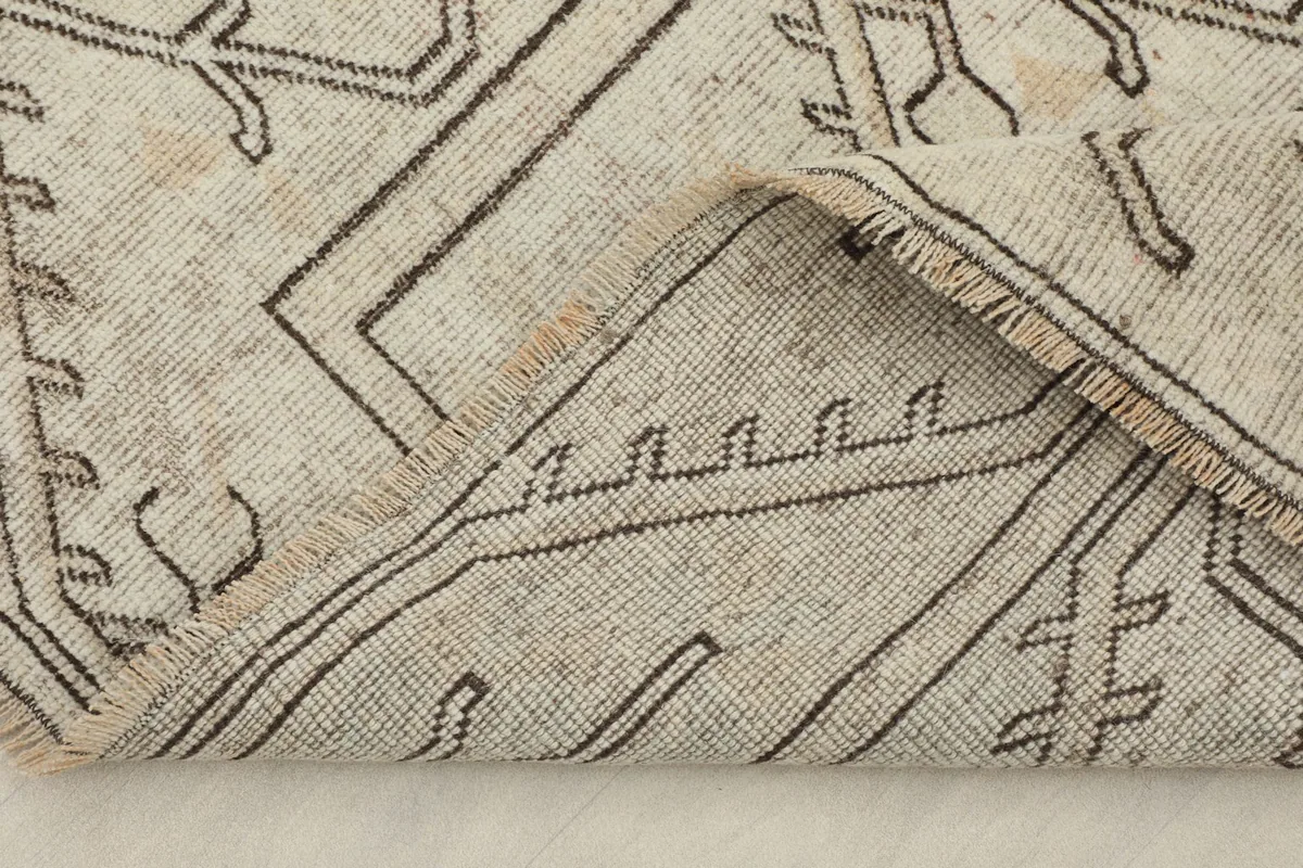 Underside of the rug, revealing the cotton foundation and hand-knotted weave