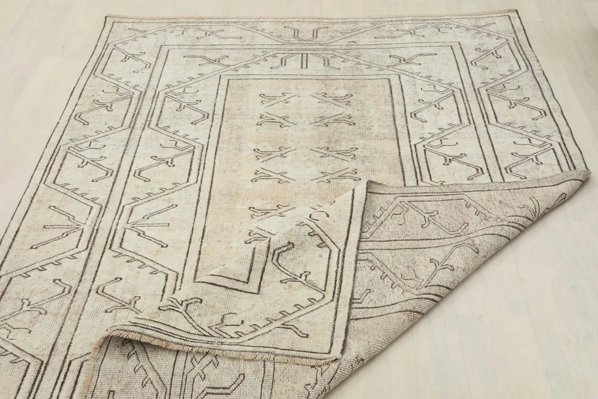 Corner of the rug folded back, showcasing the reverse side and construction