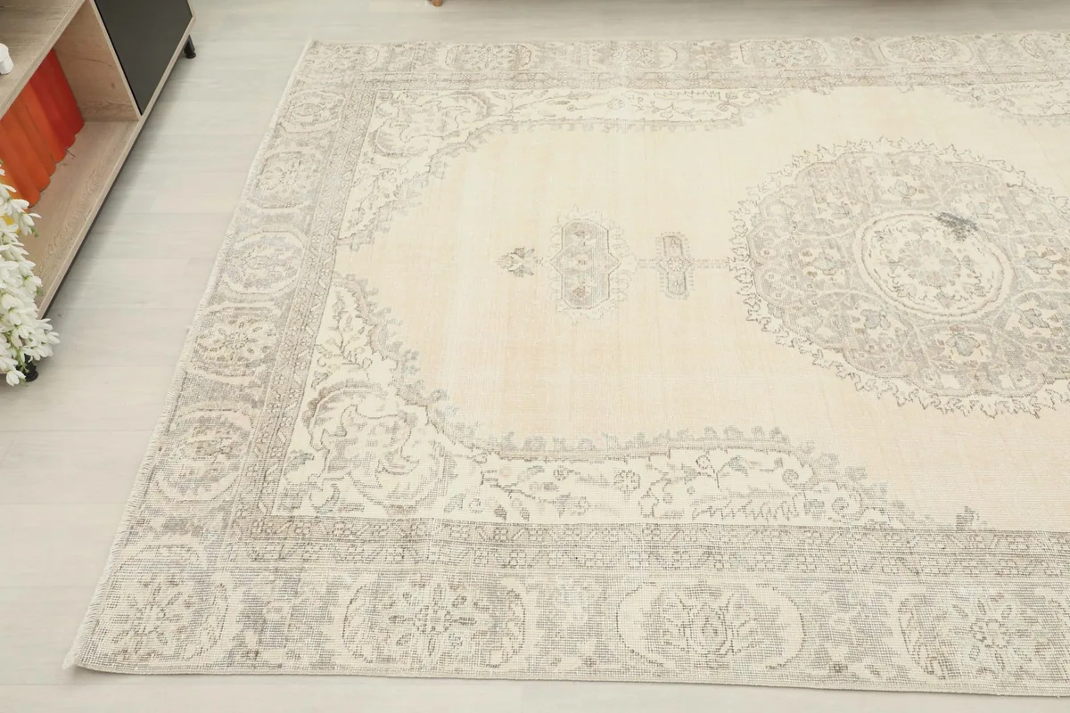 Angled view of the rug's side, featuring the intricate floral and geometric border design