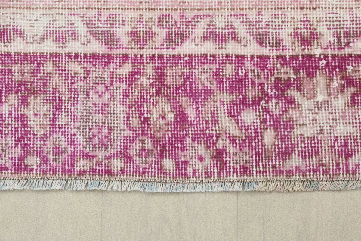Detail of the short, subtle fringes on the edge of the hand-knotted vintage rug