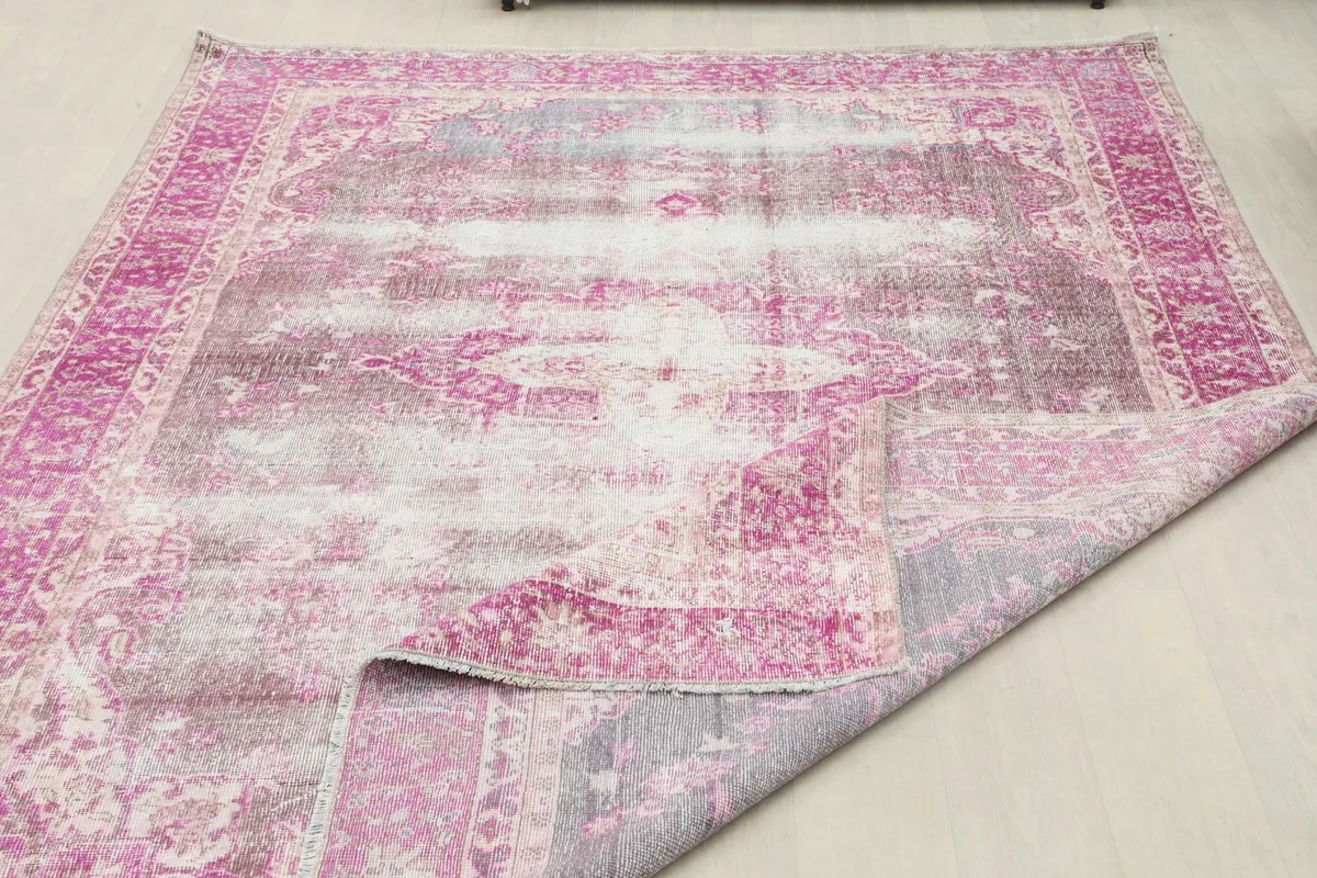 Rug partially folded, showing the flexibility and thickness of the vintage wool pile