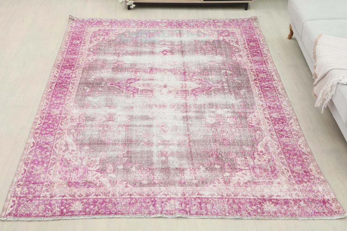 Overhead view of the 6'4" x 9'3" vintage pink and gray rug in a room setting