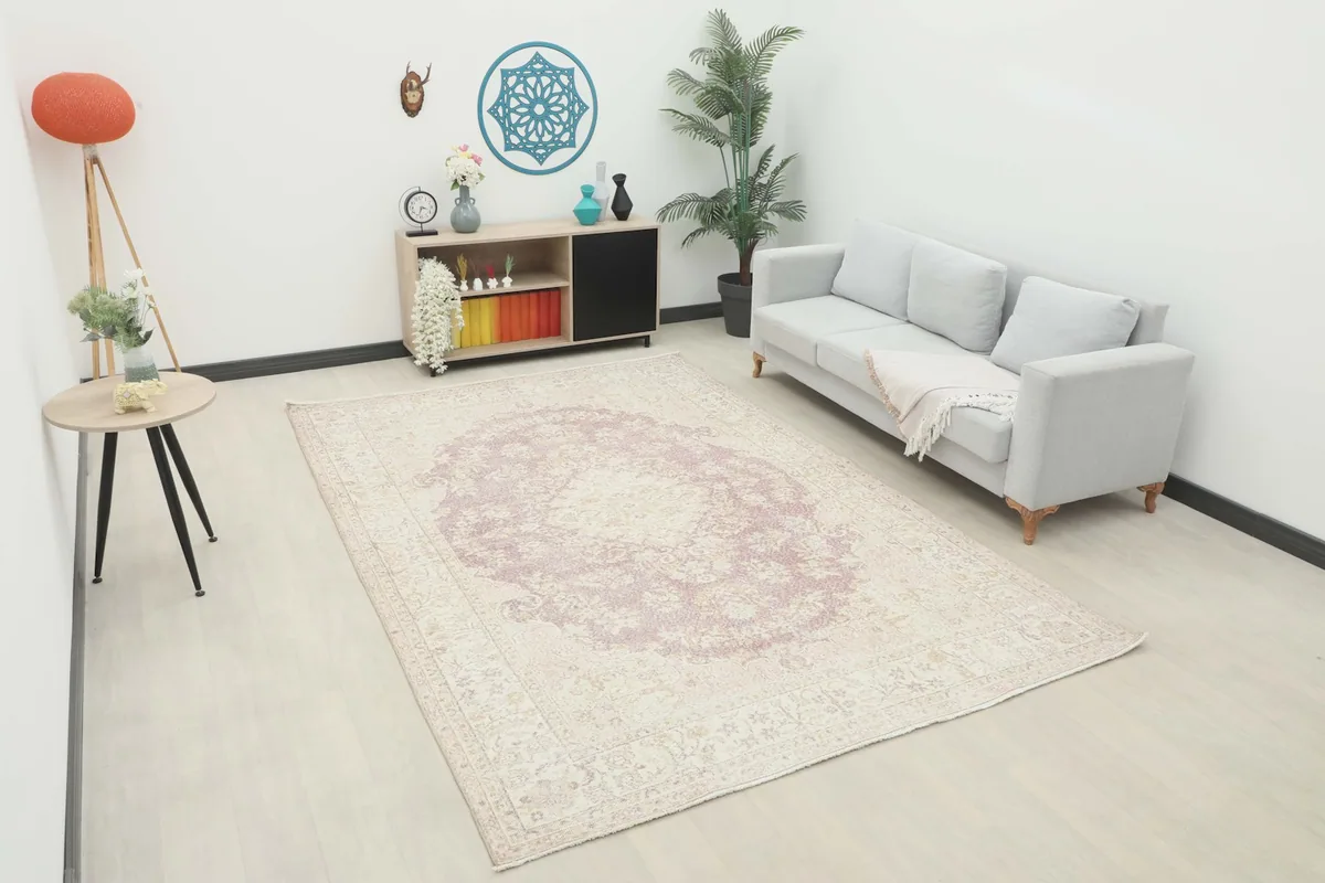 Vintage Anatolian rug in a modern living room setting with a sofa and side table, showing scale