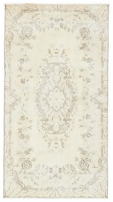 Full overhead view of the 3'6" x 6'8" ivory vintage Anatolian rug with beige floral medallion pattern