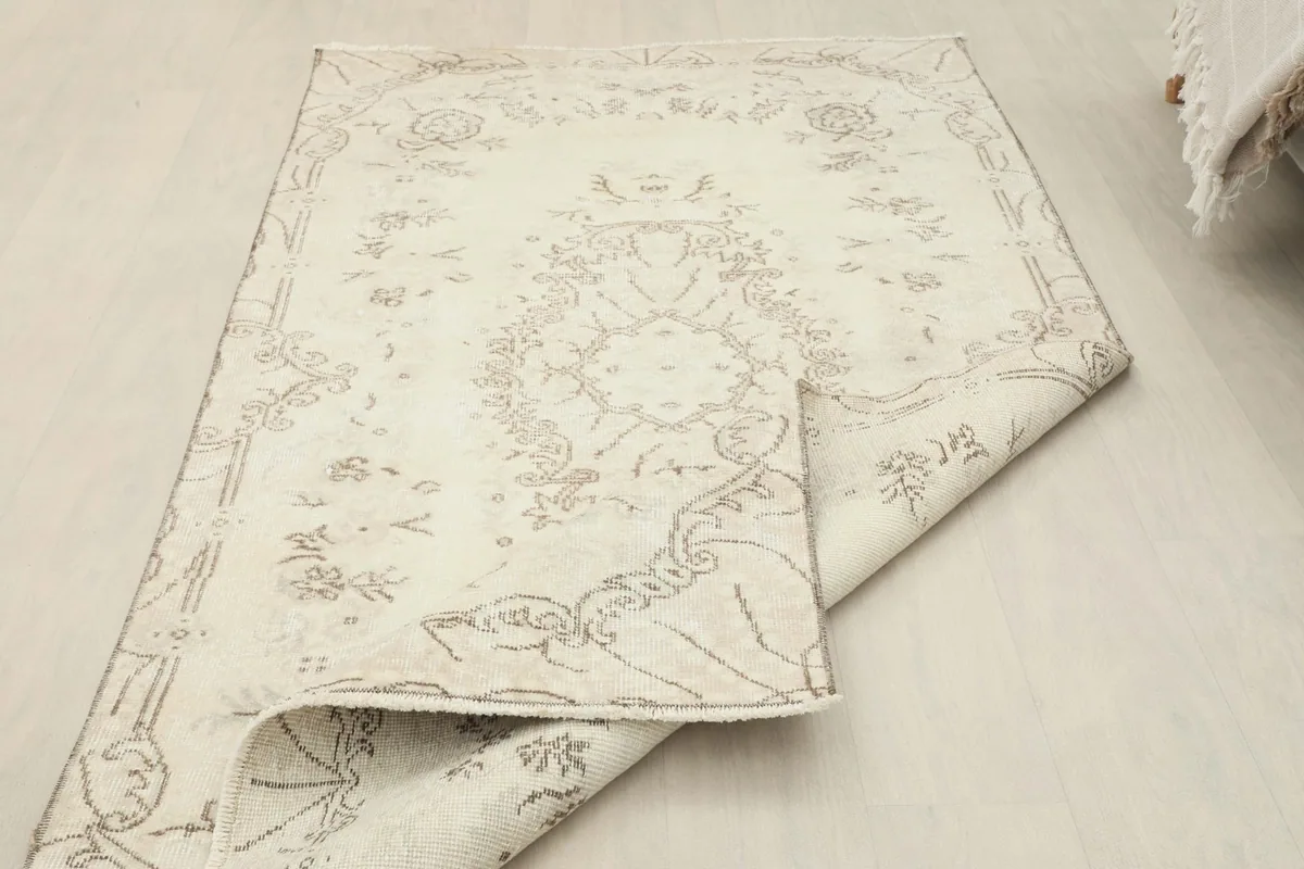 Rug partially folded, displaying the flexibility and construction of the vintage Anatolian piece