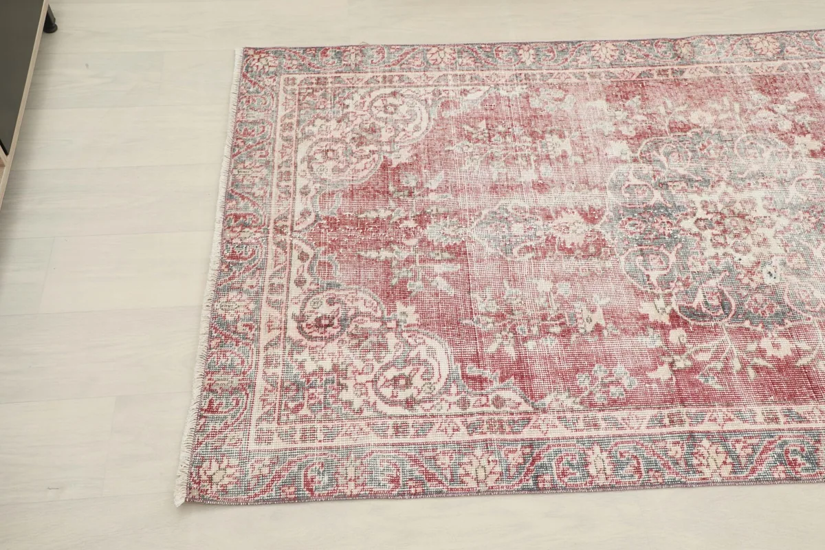 Corner view of the vintage Anatolian rug, showcasing the distressed texture and medallion details