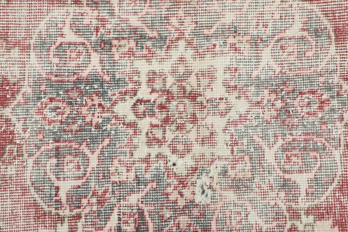 Detailed close-up of the rug's wool pile, revealing the intricate hand-knotted texture and color variations