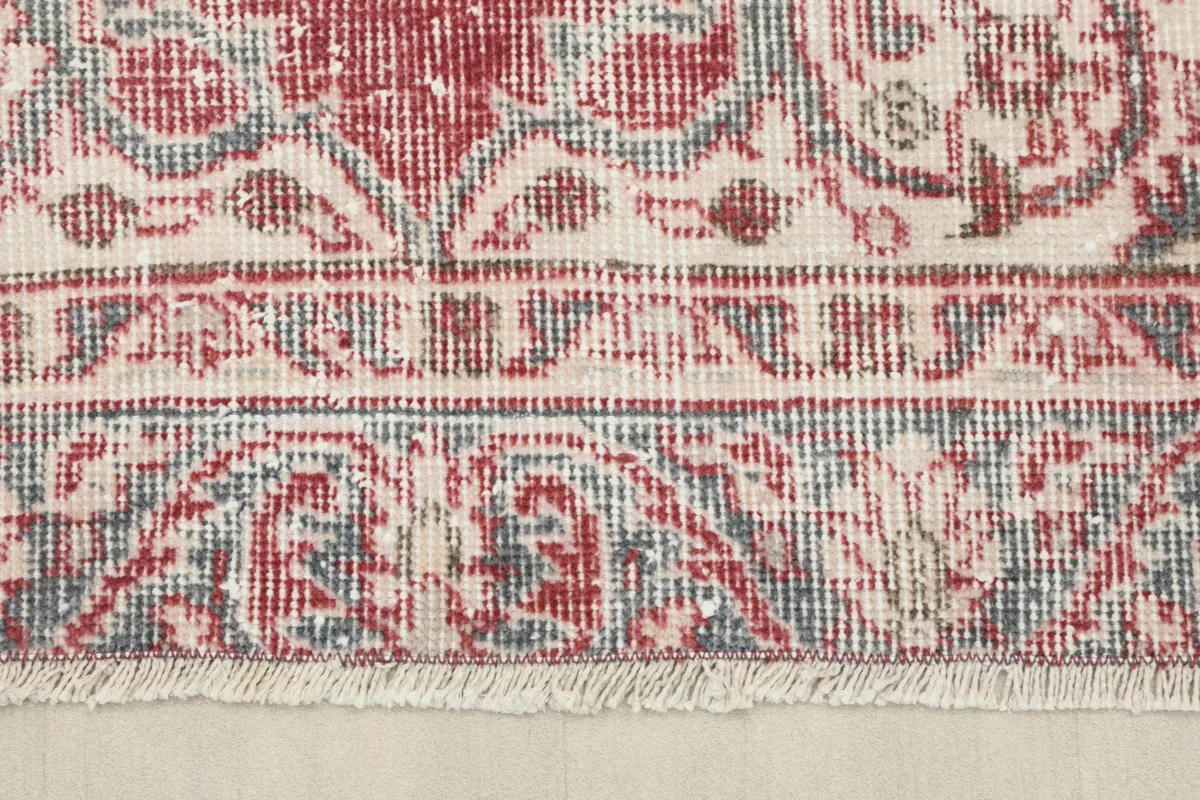 Close-up of the rug's border and short, natural fringes, showing the hand-knotted construction