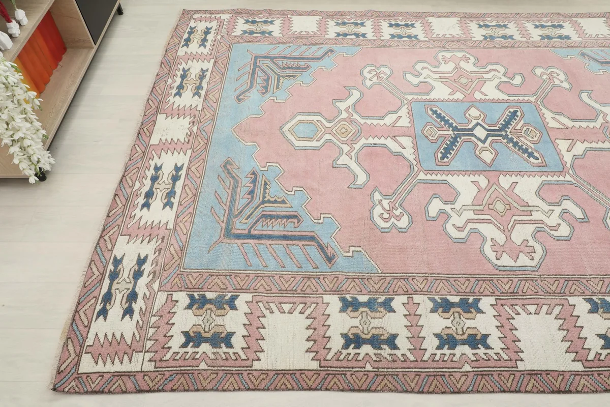 Angled shot highlighting the intricate blue and ivory geometric patterns within the rug