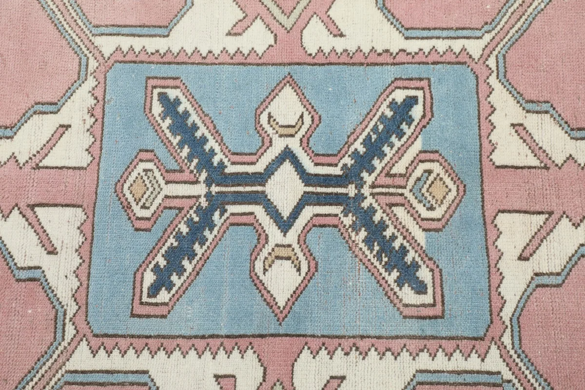 Detailed view of the central blue medallion with navy and ivory tribal motifs