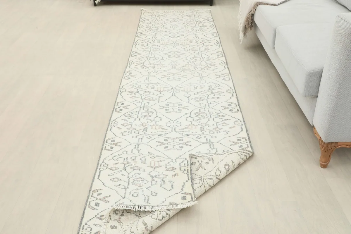 Runner rug partially unrolled in a room setting, showing its flexibility and pattern continuation