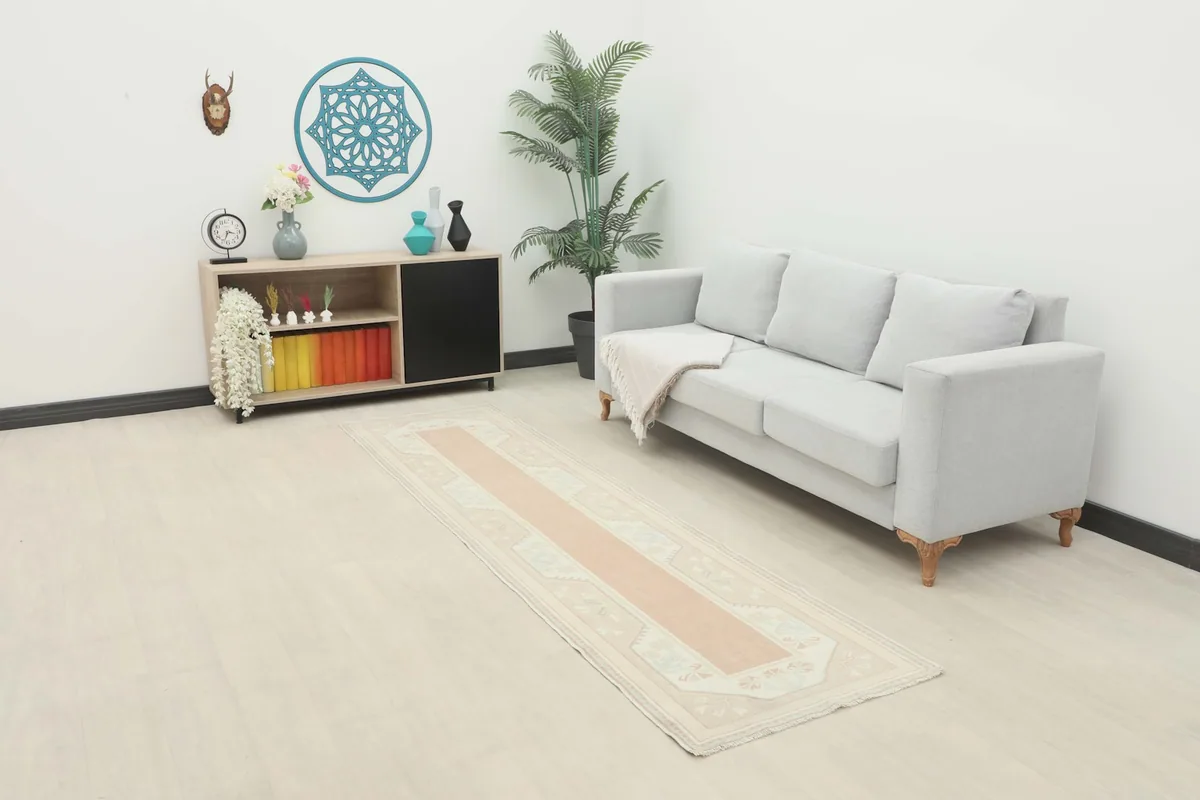 Runner placed in a room setting, extending from a sofa towards a cabinet.