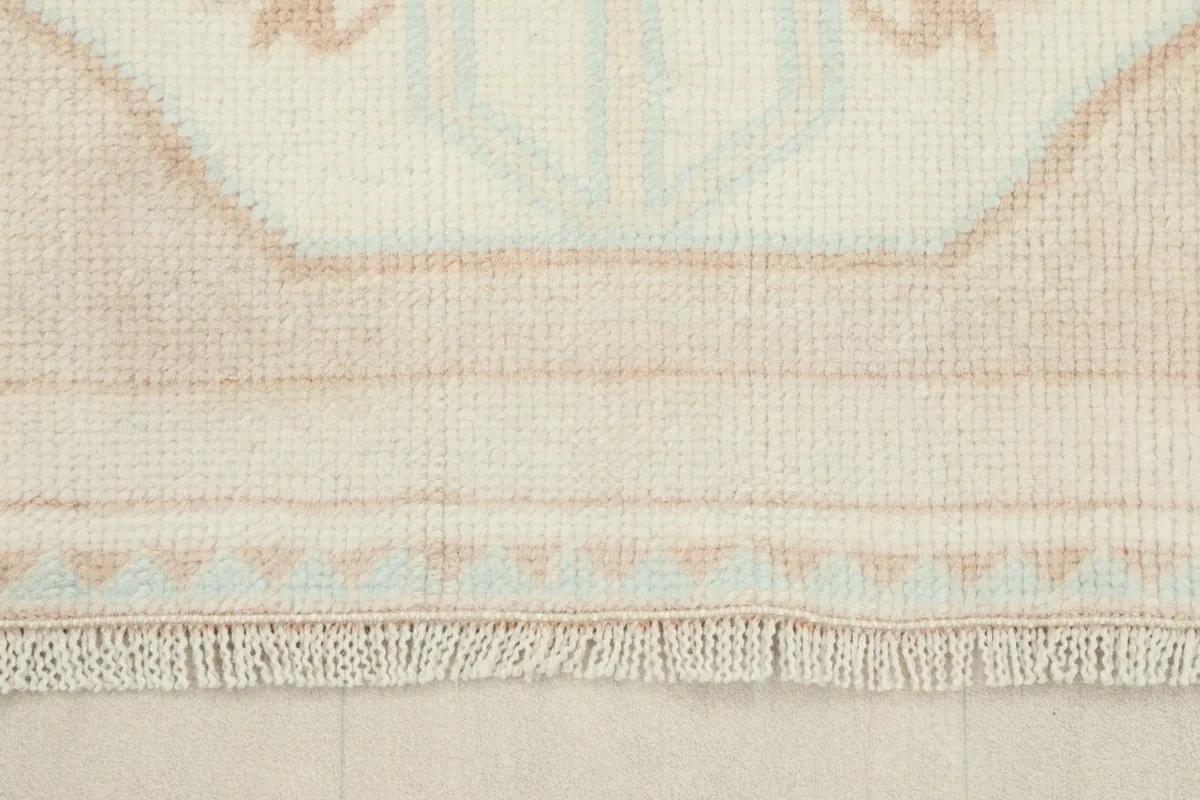 Close-up of the fringe and edge of the runner, showing the hand-knotted construction.