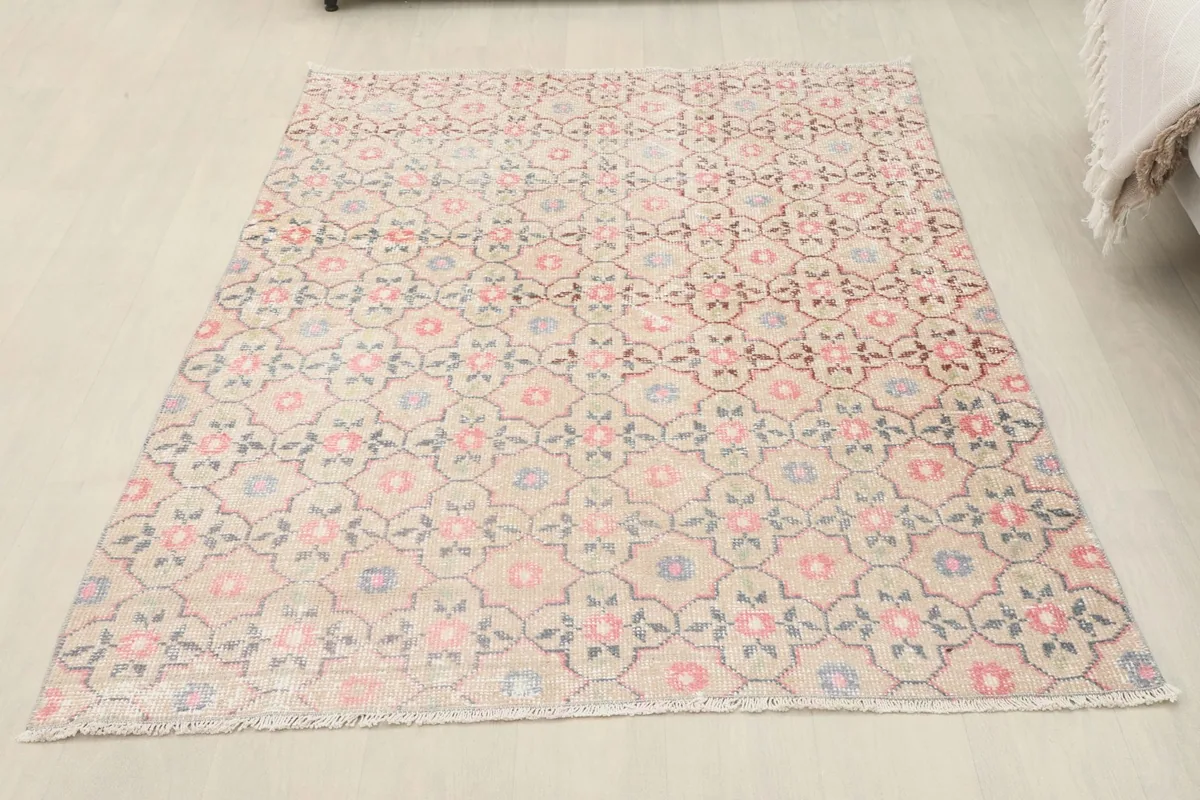 Full overhead view of the rug, showcasing its rectangular shape and uniform floral geometric design.