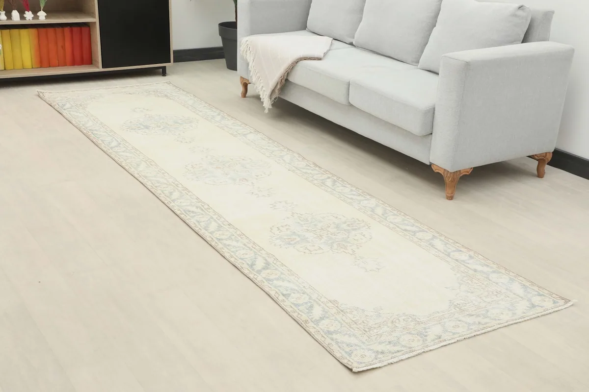 Angled view of the vintage runner rug in a room setting, showing its length and placement.