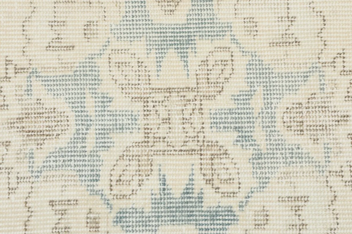 Extreme close-up showing the hand-knotted wool pile and weave texture of the rug.