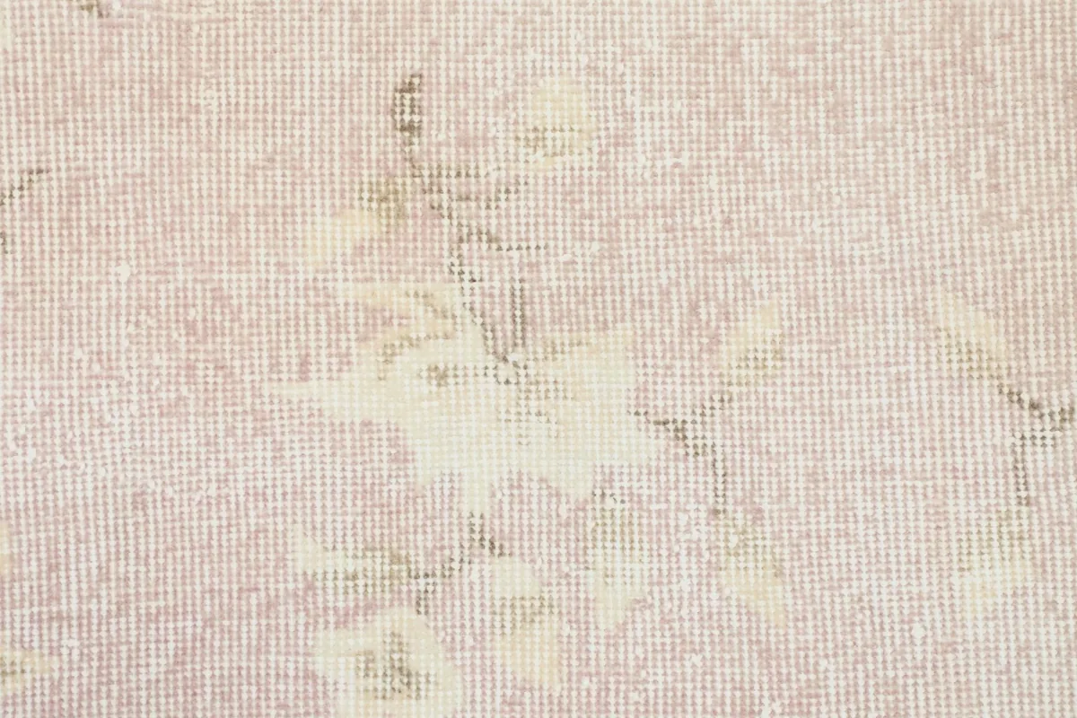 Close-up showing the low pile texture and weave of the hand-knotted wool rug.